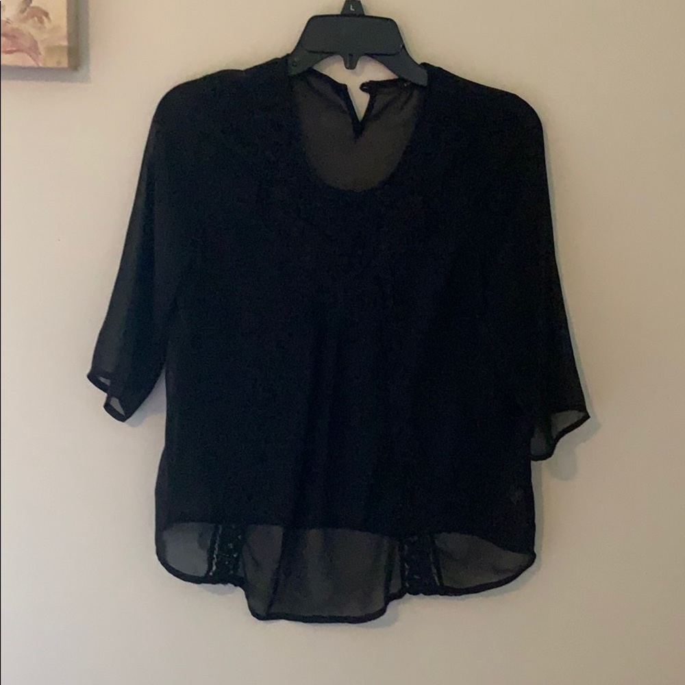 Black blouse with lace design on the front